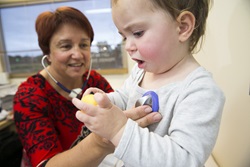 A child health nurse listening to the heart of a toddler using a stethoscope