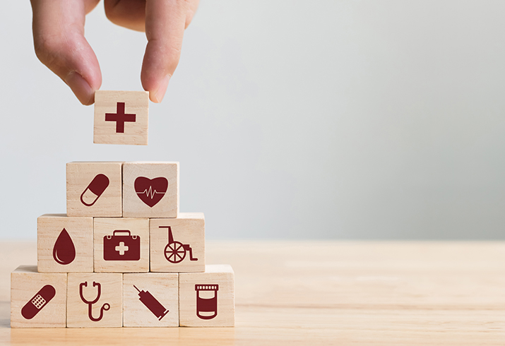 Cubes with health icons stacked in a pyramid