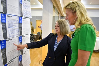Commissioner for Children and Young People Jacqueline McGowan-Jones and CAHS Chief Executive Valerie Jovanovic review feedback from the Symposium