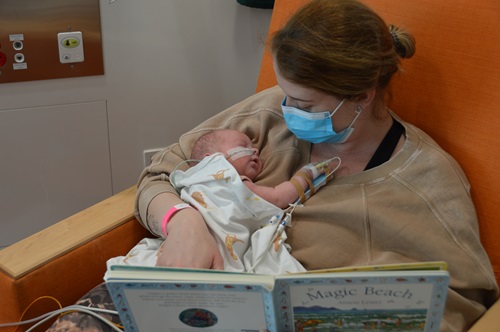 Baby Biggs being read to by mum in the NICU