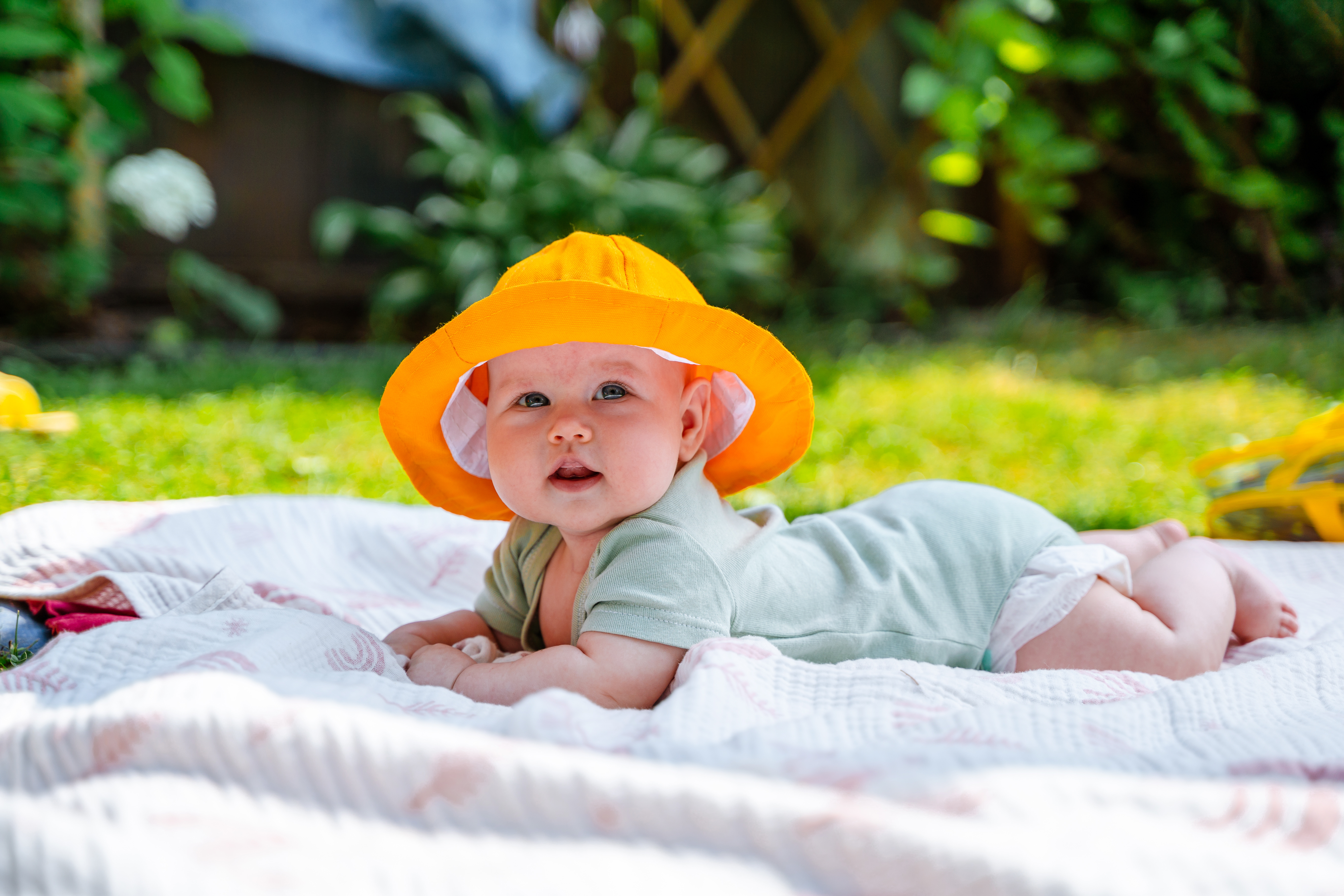 Baby in the sun with a hat on