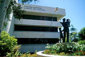 Front of Princess Margaret Hospital with sculpture of father and children looking towards sign and kite emblem